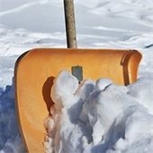Yellow shovel sitting in the snow