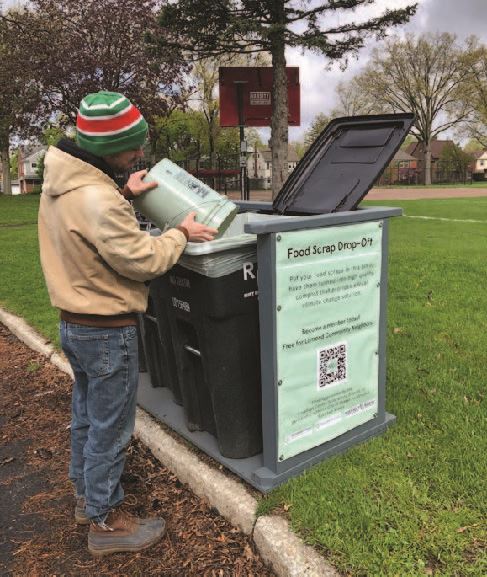 Resident dropping off food scraps at a Rust Belt Riders bin at Lomond Elementary School